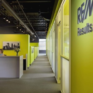 Woman at reception desk in modern colorful office space