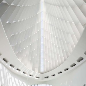 Two people walk under main entrance hall of Milwaukee Art Museum