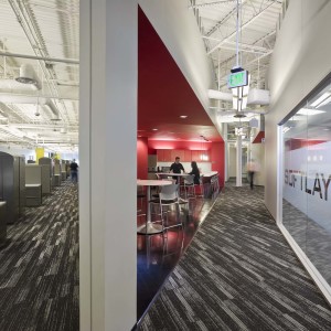 Modern employee break room cut into triangular shape with offices on both sides