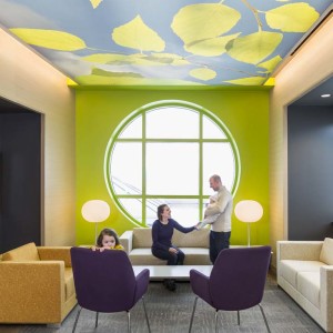 Family hanging out in colorful sitting area in children's pain clinic in hospital