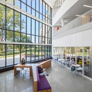 Students hanging out in large atrium of new university building