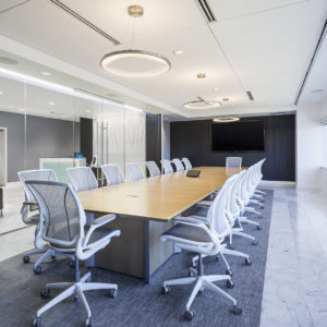 Large black and white conference room with view out glass wall to reception area