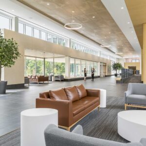 Long entrance lobby of school with floor to ceiling windows