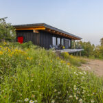 Burnt Rock cabin late afternoon surrounded by wildflowers