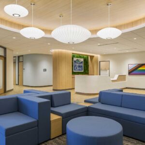 Lobby of healthcare clinic with circular tray ceiling and colorful modern furniture