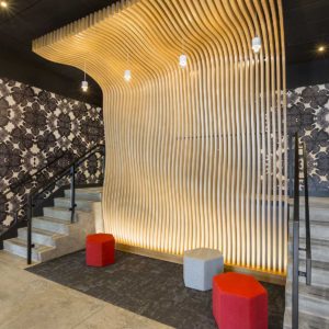 Entrance lobby to new apartment building with unique laser cut wood “wave wall”