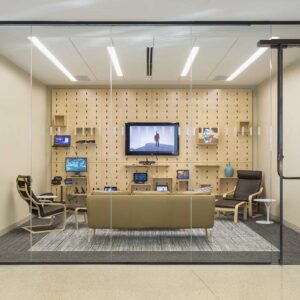 Modern media room seen behind floor to ceiling glass wall