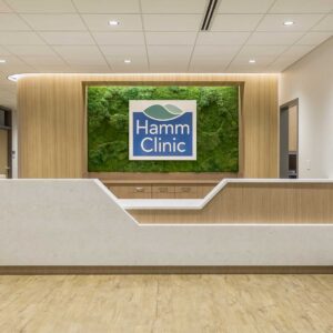 Front reception desk at health clinic with modern quartz and wood materials