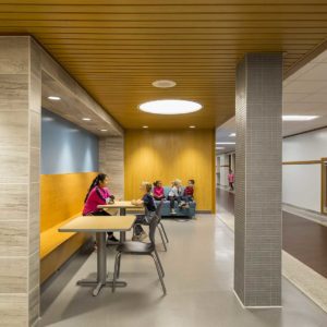 Students talking in new seating and gathering area in grade school