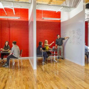 People working in colorful work nooks of web design and marketing company